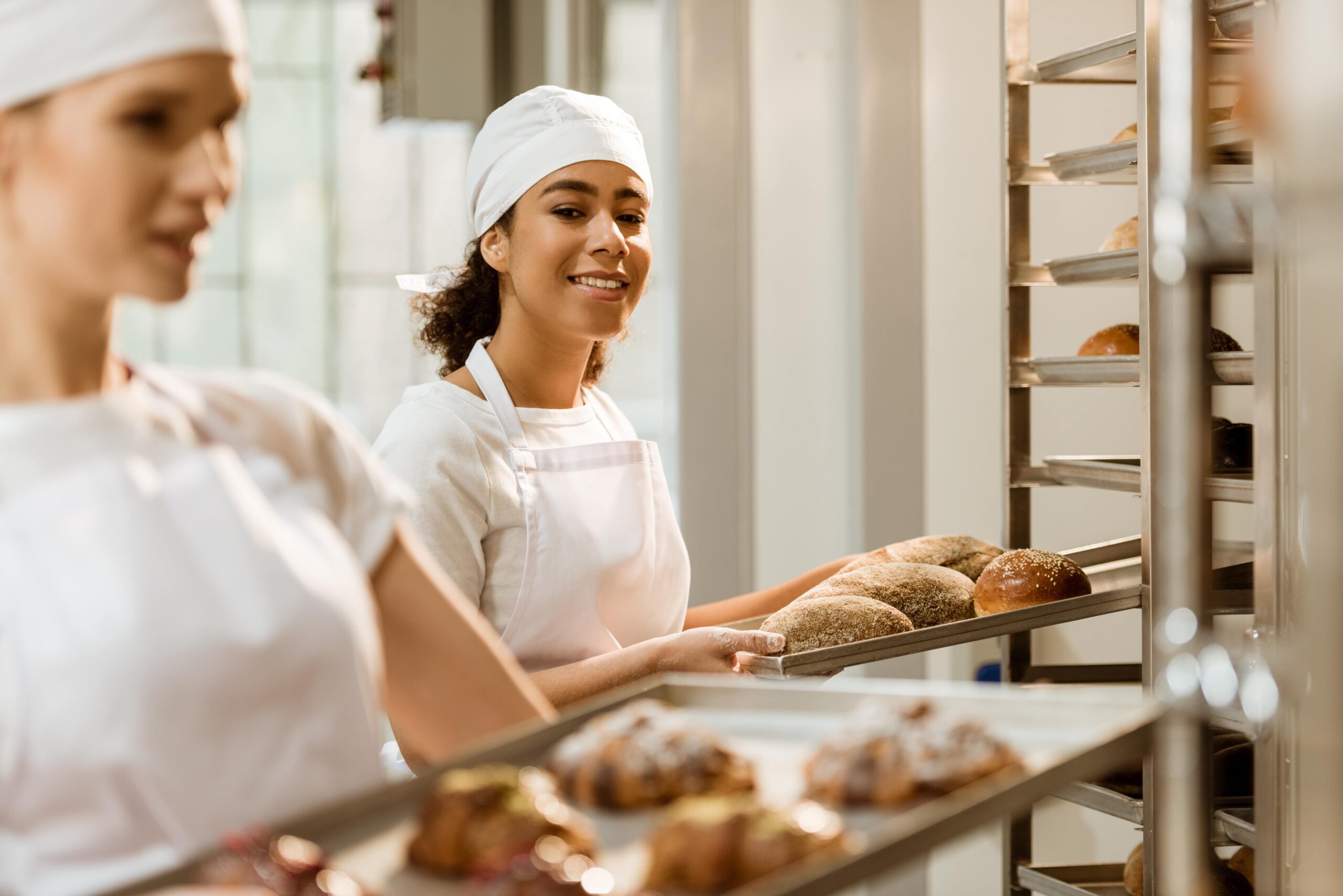 young-female-bakers-working-together-at-baking-man-2023-11-27-04-59-22-utc-min